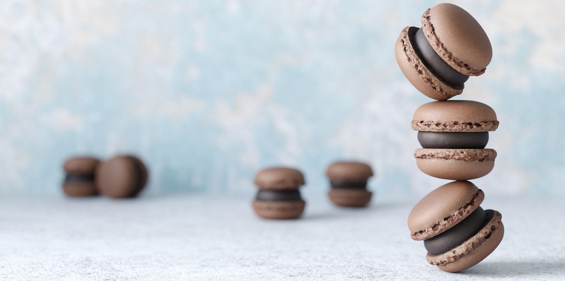 photorealistic close up rendering of a group of chocolate macaron 3d models on concrete